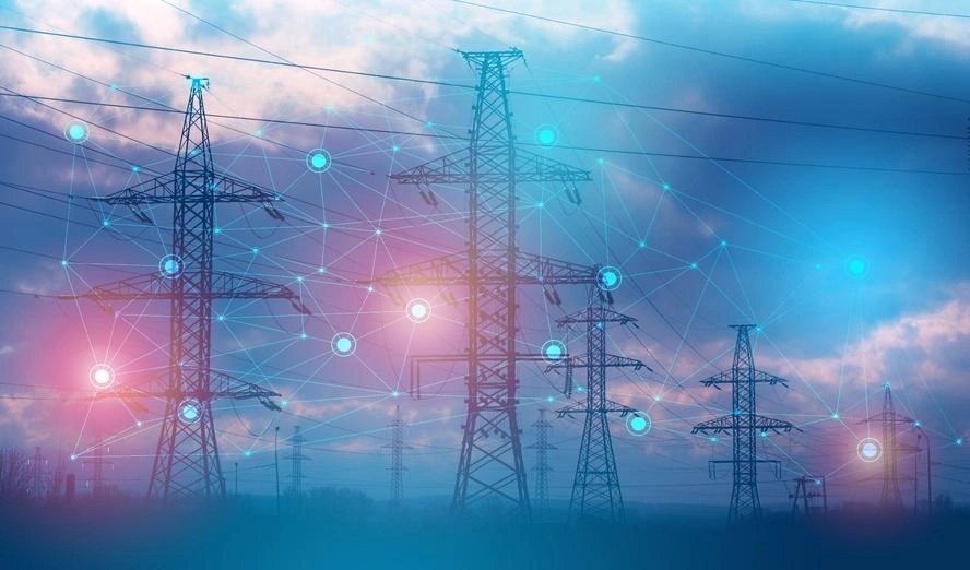 High-voltage power transmission lines against the sunset, symbolizing U.S. efforts to expand grid capacity for AI and data centers.
